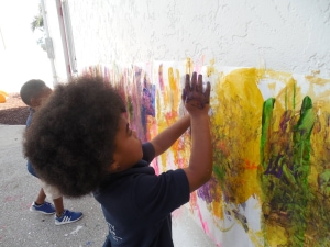 Student finger painting at Horizons Unlimited Christian Academy
