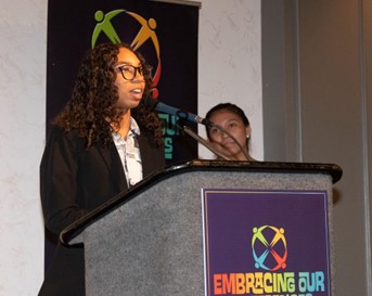 Taiz Caminero speaking at the 2022 annual luncheon for Embracing Our Differences. 